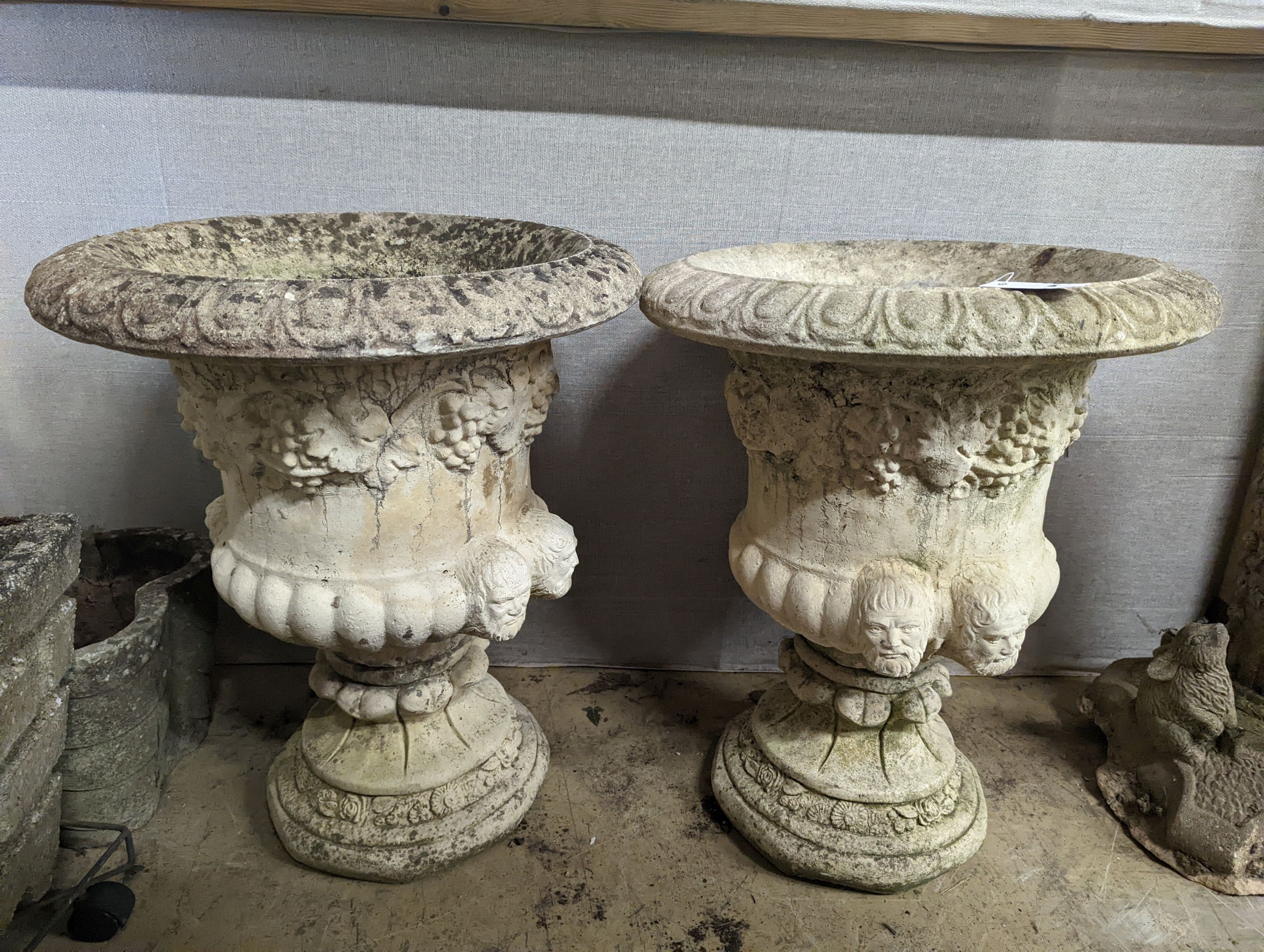 A pair of reconstituted stone campana garden urns, diameter 54cm, height 64cm